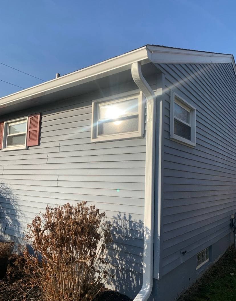 Gutter and downspout installation on vinyl siding home — Metro Detroit